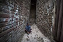 06-01-2015_21_39_00 3 - A handicapped woman is seen at a narrow alley at a slum in Islamabad.JPG