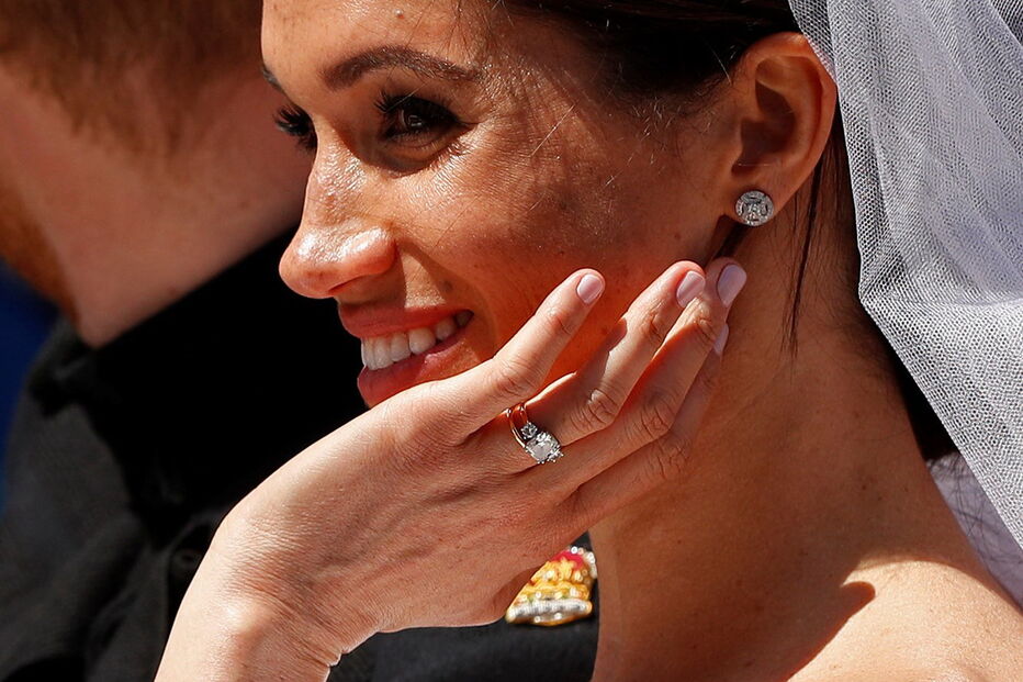 Recém-casados Harry e Meghan acenam à multidão em carruagem