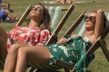 Mulher aproveitam o bom tempo para apanhar sol