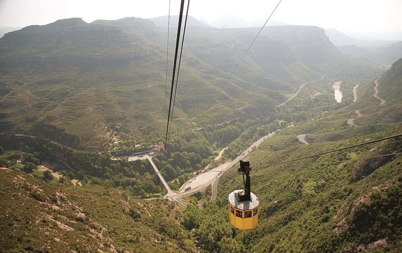 Teleférico ajuda os turistas a subir a montanha de Montserrat desde a estação de comboios
