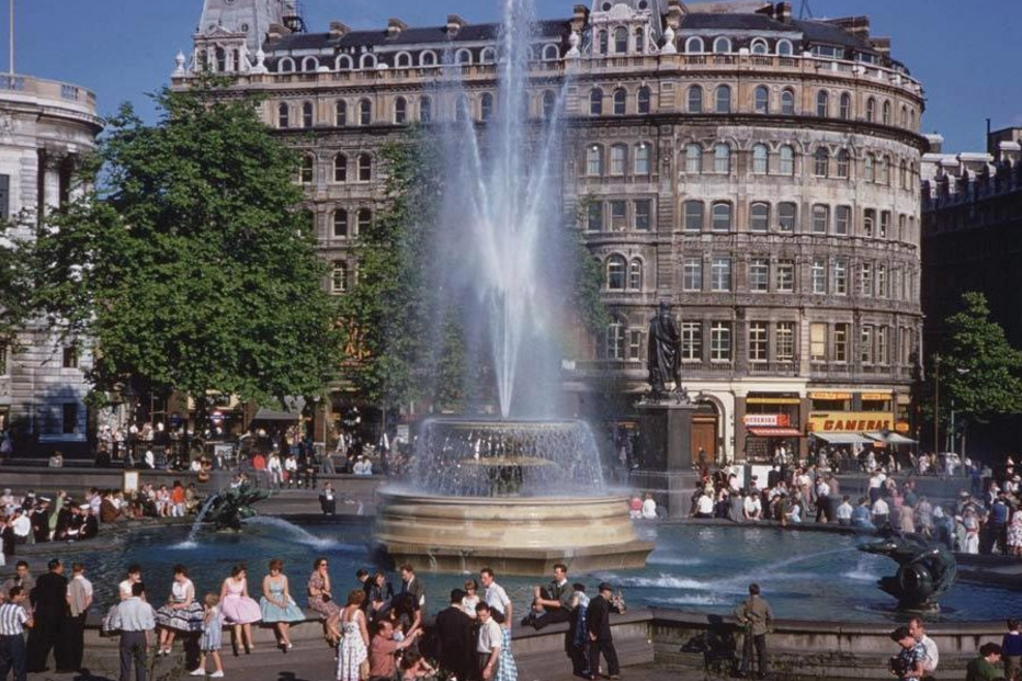 Pessoas sentadas em volta da fonte de Trafalgar Square em meados dos anos 50
