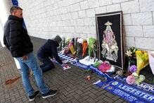 Adeptos do Leicester City deixam flores junto ao estáido onde helicóptero caiu