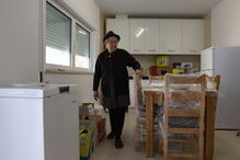 Rosalina Rosa na cozinha da casa nova, onde falta ligar os eletrodomésticos