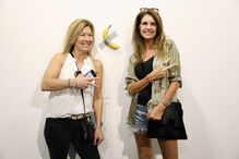 Várias pessoas posam com a obra de arte 'Comediante'