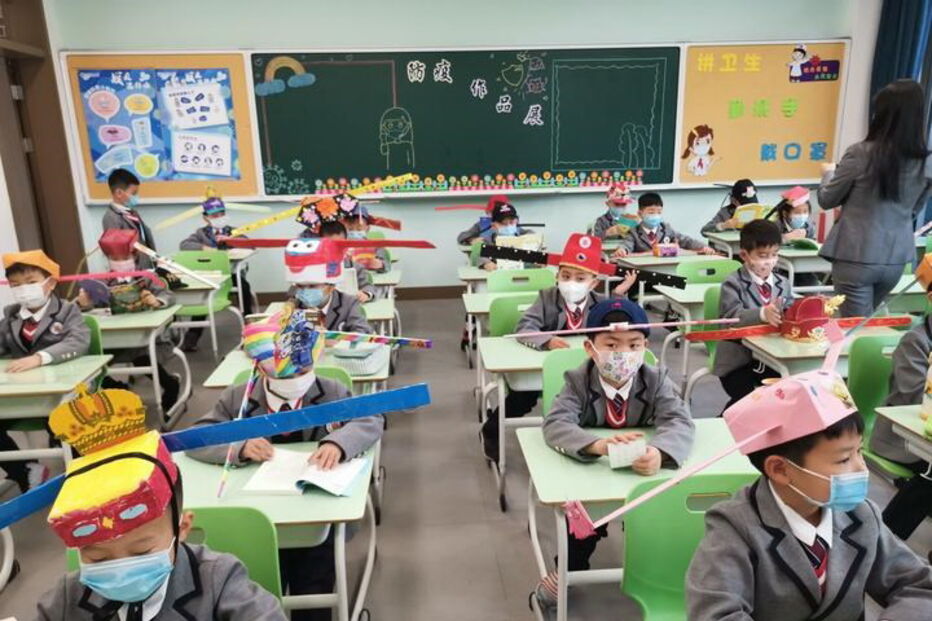 Crianças chinesas utilizam chapéus de um metro para manter distância social na escola