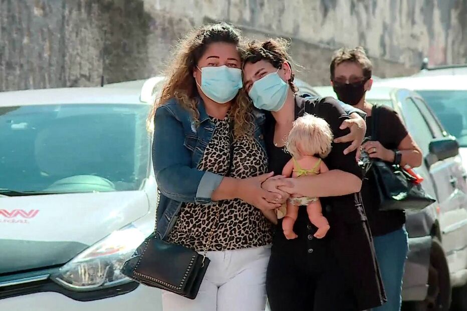 Inês Tomás (à direita), mãe da menina que foi brutalmente assassinada, agarrada à boneca da filha no funeral