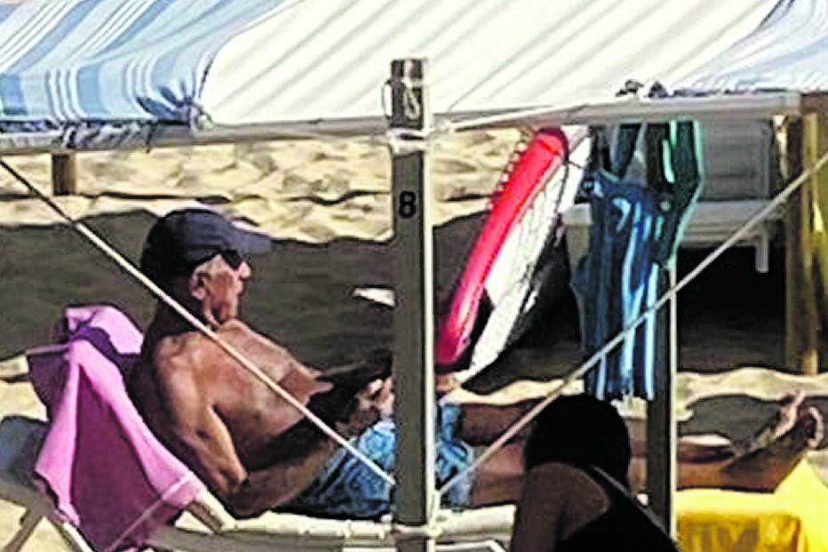 Marcelo Rebelo de Sousa numa espreguiçadeira do areal algarvio na companhia de uma mulher