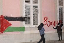 Manifestantes pintam bandeira da Palestina na fachada do Ministério dos Negócios Estrangeiros