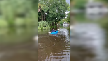 Moradores andam de caiaque nas ruas inundadas depois da passagem do furacão Debby na Florida 