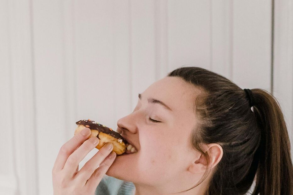 mulher feliz a morder donut