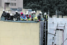 Lisboa. Trabalhadores tentam puxar parte de uma estrutura de andaimes que desabou devido à tempestade ‘Martinho’