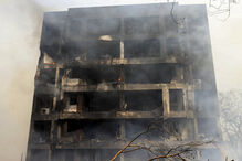 Edifício com estragos e fumo após incêndio