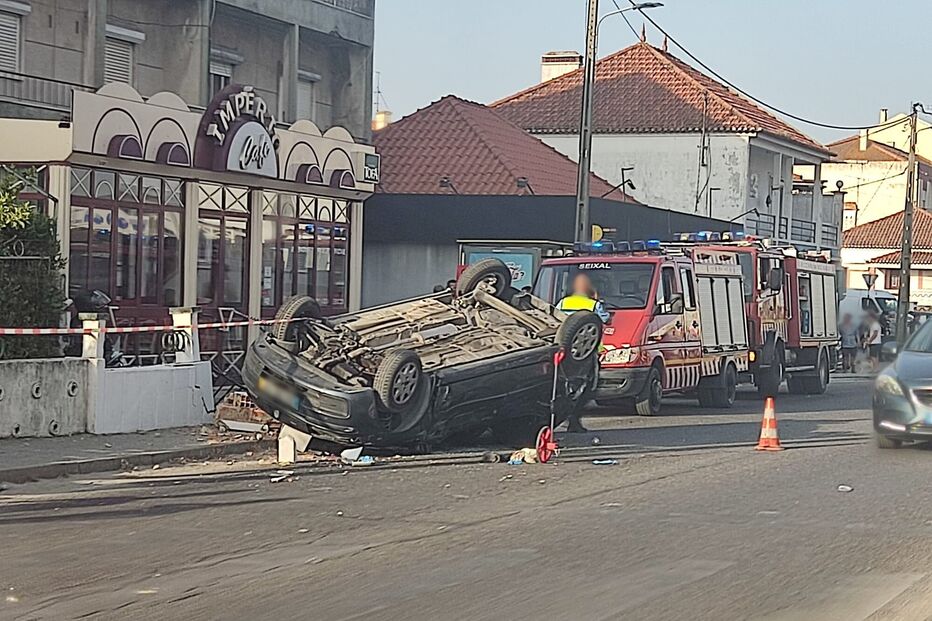 Carro capotado junto a café com bombeiros no local, em Seixal