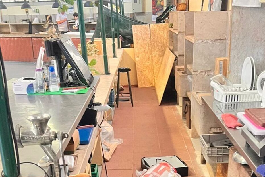 Espaço comercial apresenta desordem, com objetos espalhados no chão e bancadas