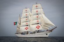 Veleiro português com a Cruz de Cristo nas velas e a bandeira de Portugal hasteada