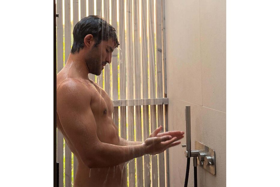 Um homem toma duche ao ar livre