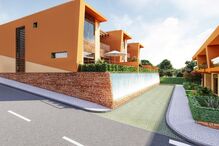 Casas modernas destacam-se numa rua soalheira com arquitetura inovadora