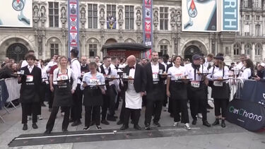 Qual é o garçom mais rápido? Empregados de mesa correm pelas ruas de Paris com bandejas carregadas na mão