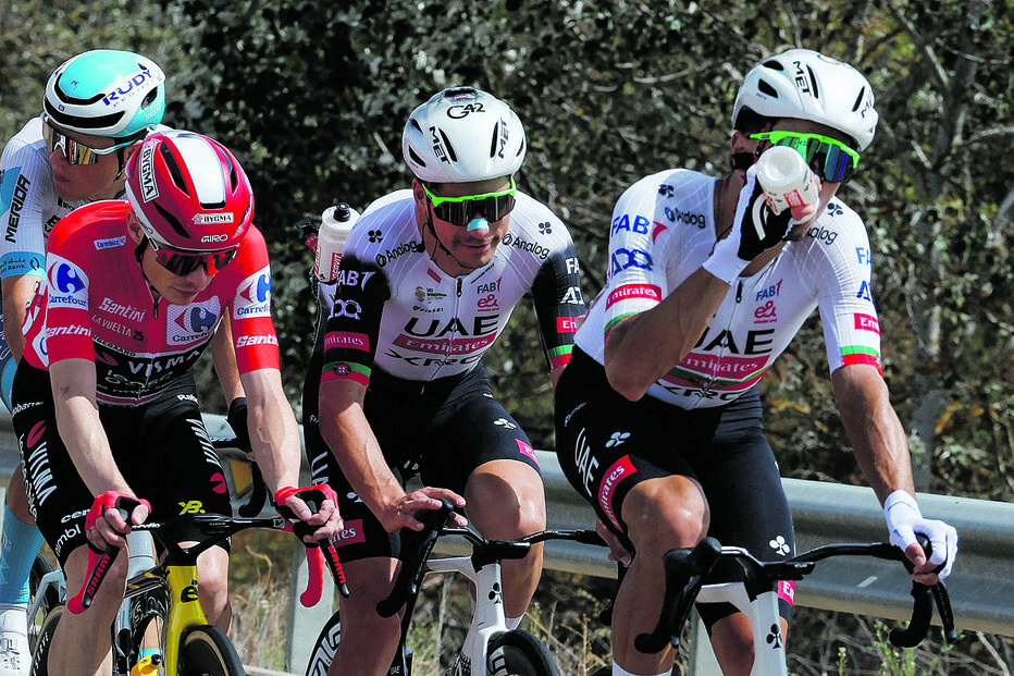 Vingegaard, de vermelho (camisola de líder), ao lado dos portugueses João Almeida e Ivo Oliveira