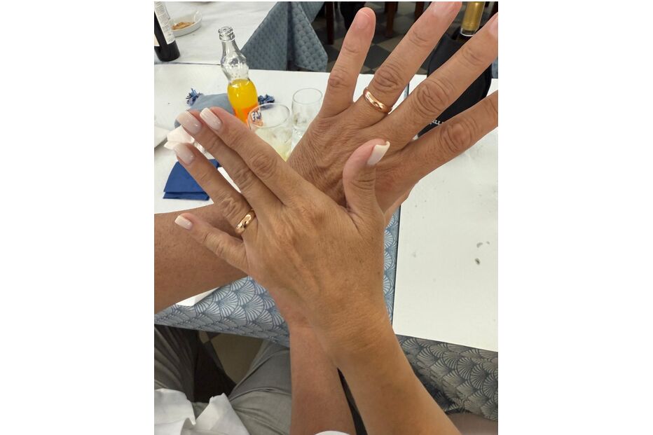 Um casal exibe as suas alianças de casamento