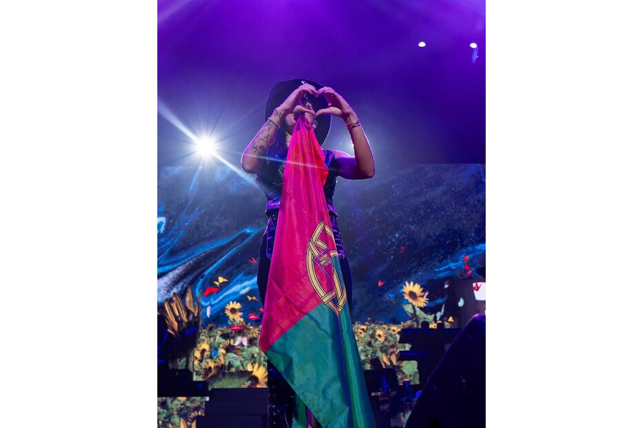 Artista mostra a bandeira de Portugal e faz um coração com as mãos