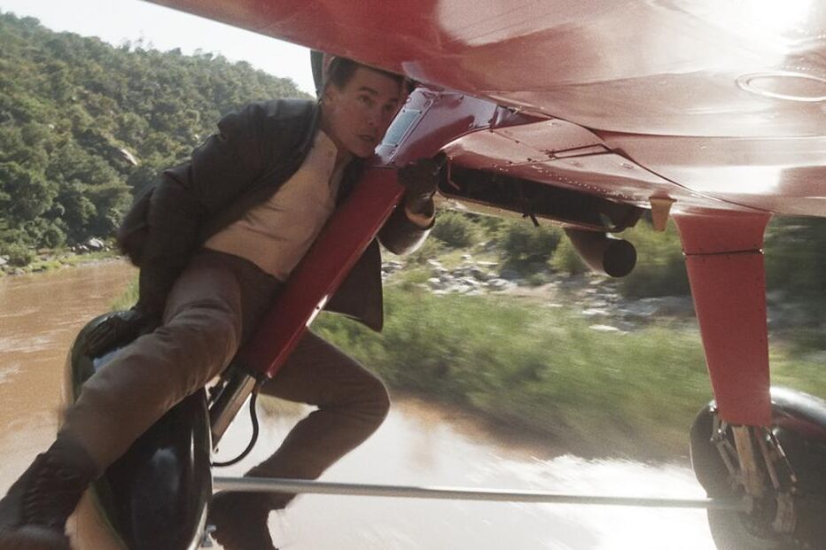 Tom Cruise faz acrobacia num avião em filme de ação familiar.

