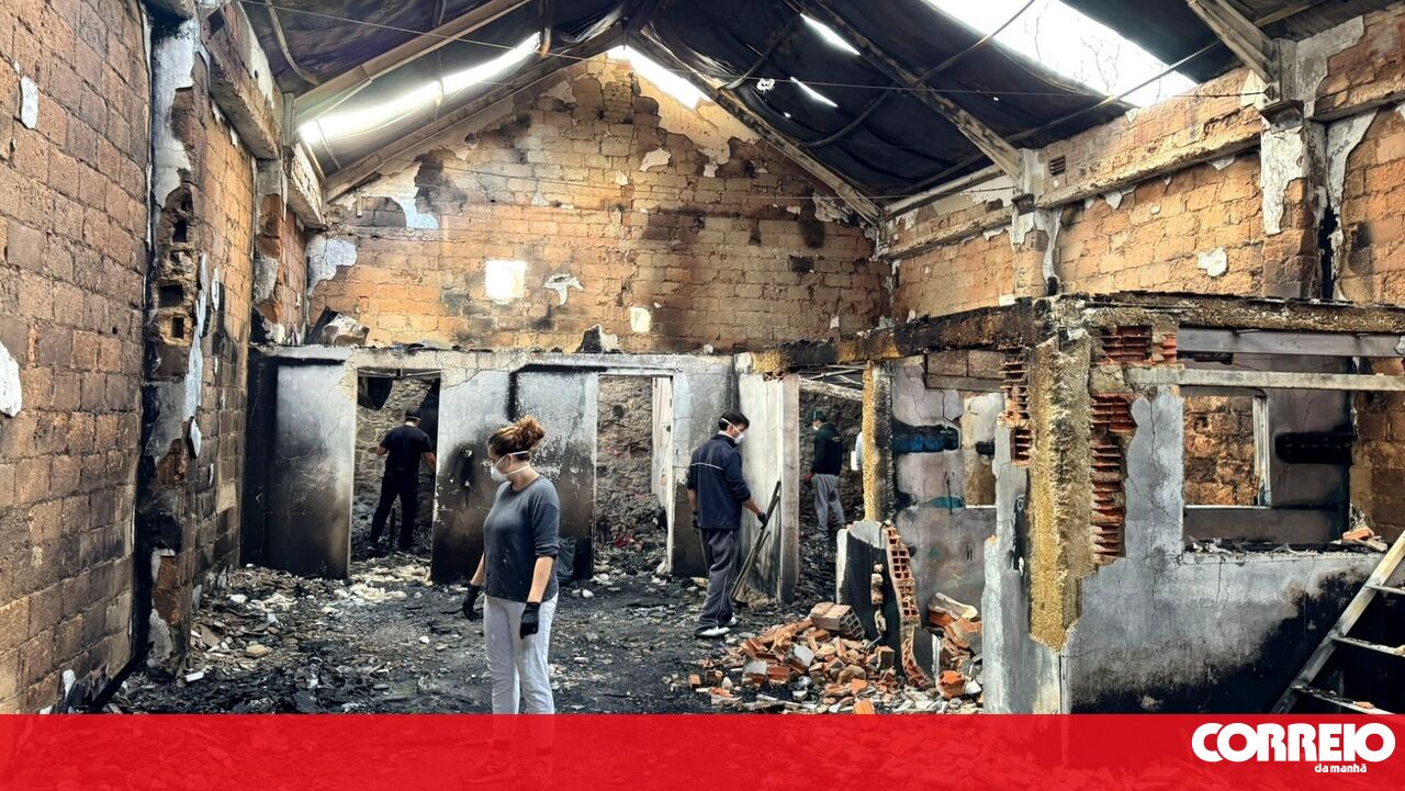 A group of volunteers rolled up their sleeves to help clear debris from a surfboard factory destroyed by fire