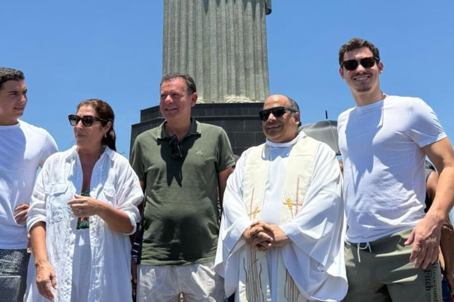 Montenegro com família e padre no Rio de Janeiro, tendo o Cristo Redentor como pano de fundo