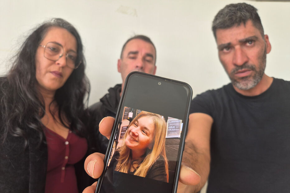 Família mostra foto de ente querido num telemóvel