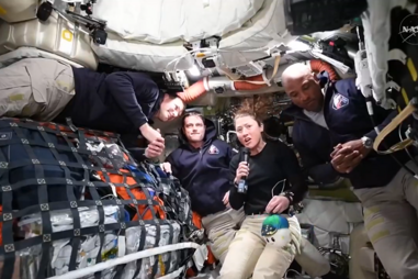 A astronauta Christina Koch segura no peluche Rise