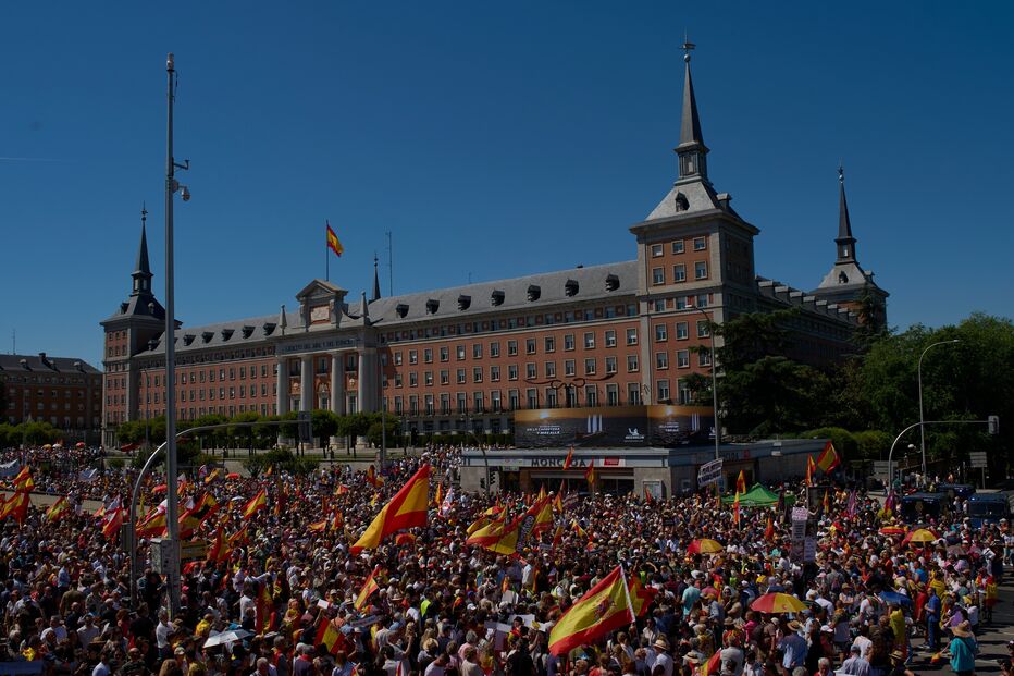 Manifestantes com bandeiras espanholas participam num protesto contra o governo do primeiro-ministro Pedro Sánchez em Madrid, Espanha, no sábado, 23 de maio de 2026.