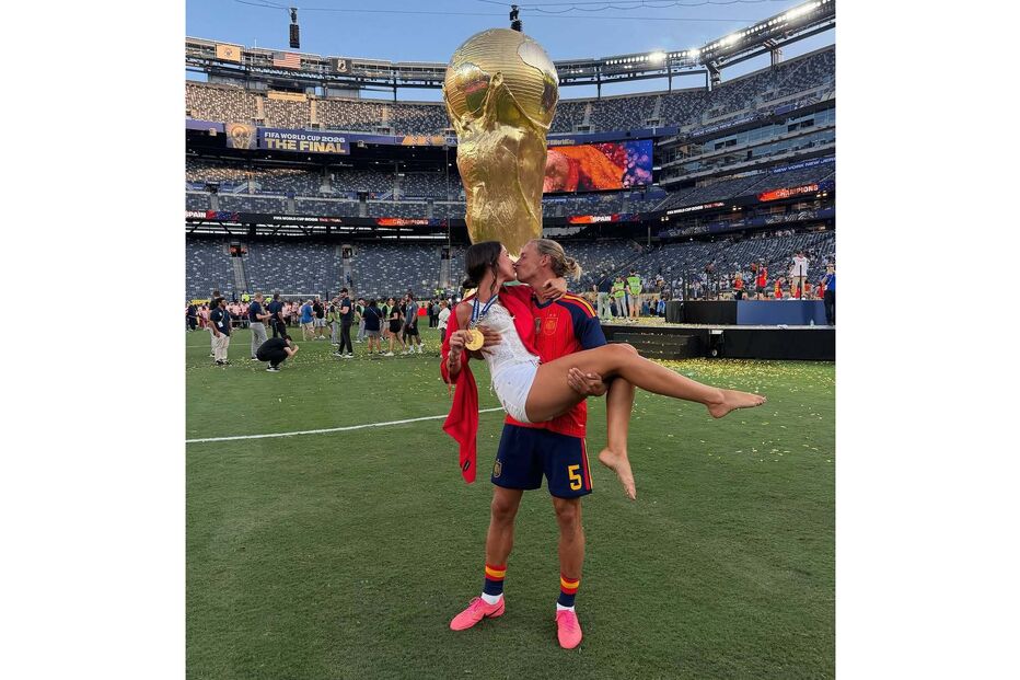 Casal beija-se em campo com troféu da FIFA e medalha de ouro