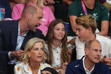Britain's Prince William, left, speaks with children Princess Charlotte and Prince George as they sit at the Sir Chris Hoy