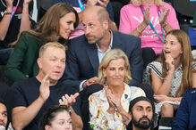 Britain's Kate, Princess of Wales, and William, Prince of Wales with Princess Charlotte sit behind Chris Hoy and Sophie, Duchess