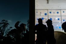 People observe the partial lunar eclipse as seen over a