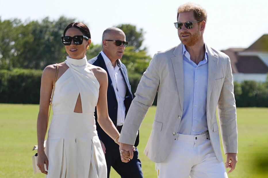 Britain's Prince Harry, right, and wife Meghan Markle, Duchess of