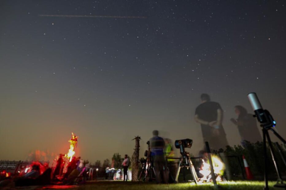People gather to watch the Perseids meteor shower at Al