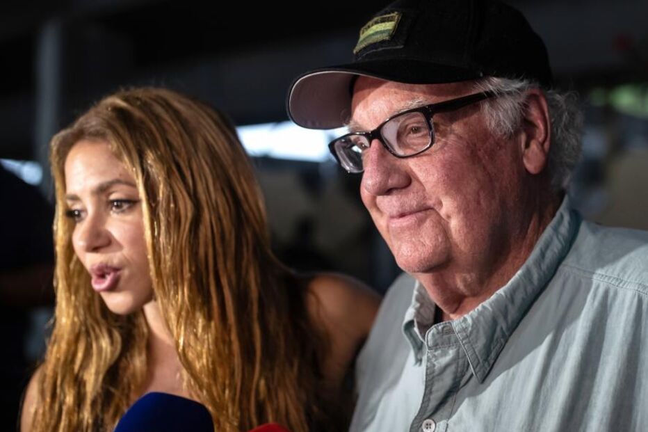 Colombian singer Shakira (L) speaks alongside American philanthropist Howard Graham]