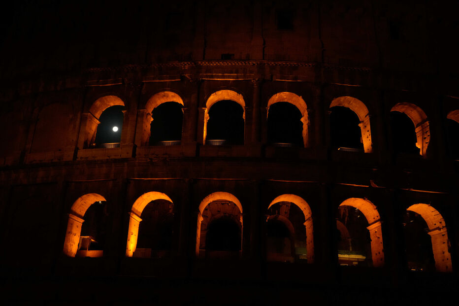 The moon sets behind the Colosseum during a partial lunar eclipse in Rome, Friday, Aug. 28, 2026. (AP Photo/Gregorio Borgia)