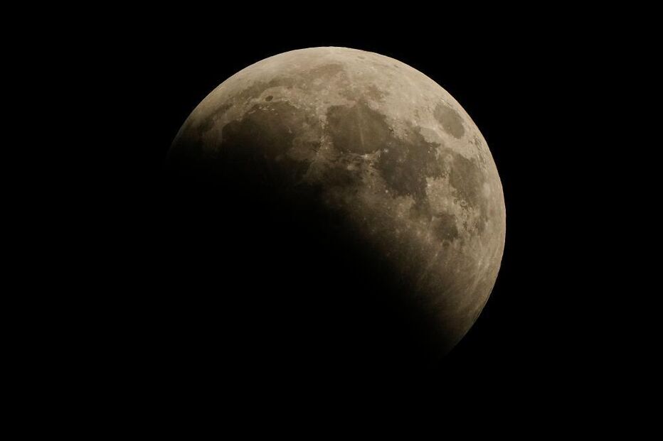 A partial lunar eclipse covers the full moon Thursday, Aug.
