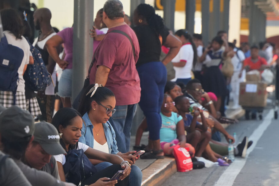People gather outside shopping mall after an earthquake hit Panama City, Friday, Oct. 9, 2026. (AP Photo/Aris Mariota)