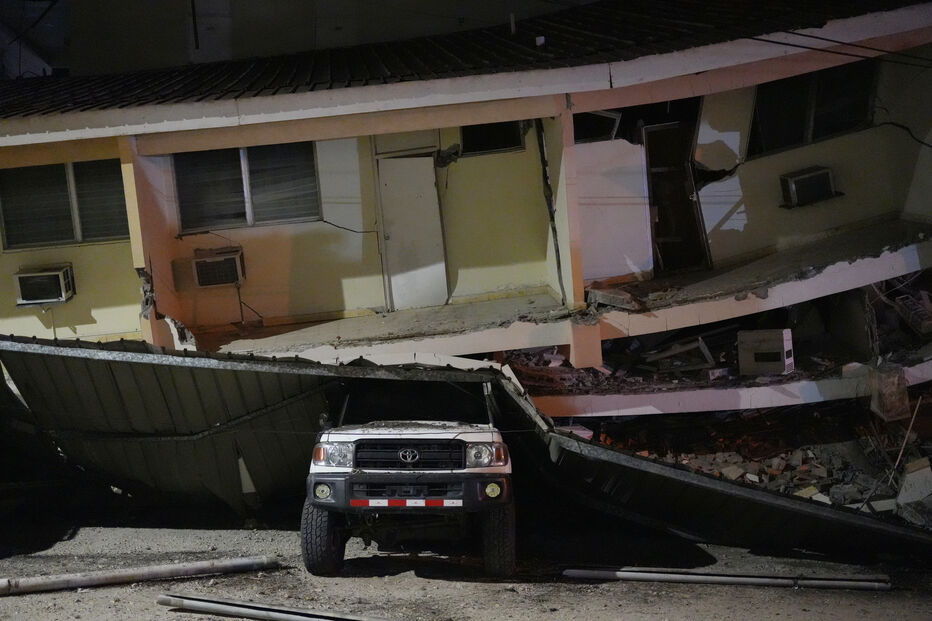 A vehicle lies crushed beneath a collapsed building after an earthquake struck Penonome, Panama, Friday, Oct. 9, 2026. (AP Photo/Aris