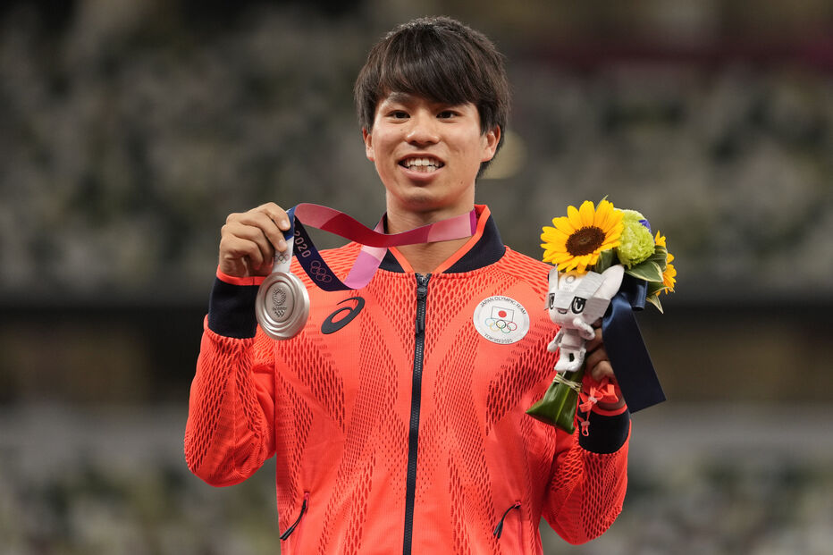 Silver medalist Koki Ikeda, of Japan, poses during the medal ceremony for the men's 20km race walk at the 2020