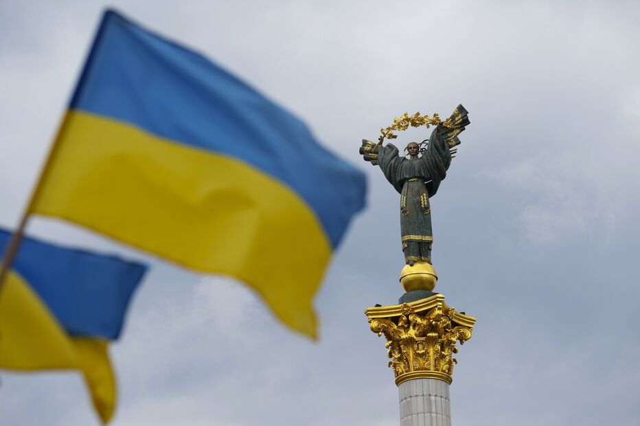 The Independence Monument is pictured as Ukrainian flags blow in the wind in Kyiv, Ukraine, on Saturday, Aug. 23, 2025.